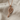 Tennis Racket Pendant, rose gold, product photo on textured fabric