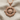 Travel Compass Pendant, rose gold, product photo on fabric