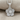 Five Petal Diamond Flower Pendant, polished silver, front view on fabric