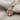 Leaf Twig Pendant, rose gold, angled close-up view on fabric