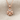 Heart clover pendant, rose gold plated silver, front view on fabric
