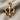 Close-up of handcrafted Poseidon trident pendant resting on textured fabric highlighting ornate metalwork.