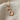 Mother Baby Footprint Pendant, rose gold, front view on textured fabric