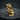 Close-up of gold vermeil thinker statue pendant resting on a dark felt pad highlighting intricate facets