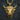 Close-up of golden bull head pendant showcasing detailed prominent horns and fierce facial expression on dark background