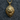 Close-up macro view of the 14K gold vermeil lion head pendant resting on a textured gray fabric background