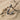 Close-up of bird letter U pendant resting on natural sand and driftwood highlighting the premium 925 sterling silver