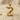 Close-up of the handcrafted 925 sterling silver bird letter Z pendant resting gracefully on textured white sand