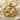 Detailed Lion Horoscope Pendant in radiant gold vermeil elegantly displayed among natural seashells and white beach sand