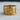 Close-up of 925 sterling silver ring with gold finish showing delicate butterfly wing details on wooden background
