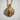 Windswept Sun Face Pendant, gold vermeil finish, front view on textured wall