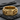 Close-up of the handcrafted resist chain ring with bold lettering resting on a textured dark slate stone surface