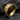 Close-up of the 925 sterling silver We Exist ring with gold vermeil finish resting on a dark textured charcoal rock surface