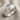 Overlapping Leaf Ring, polished silver, angled view on linen fabric