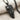 Double Horse Skull Pendant, black rhodium plated, angled view on fabric