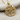 Elegant tree of hearts pendant in gold vermeil resting on soft linen fabric showing detailed craftsmanship
