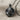 Clawing Lion Pendant in black rhodium, resting on neutral fabric