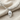 Anatomical Skull Pendant, polished silver, front view on linen with chain