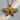 Close-up of premium sterling silver butterfly pendant with radiant gold finish resting on a light wood surface