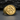 Close-up of gold vermeil interlocking Mars ring showing high relief symbols and metallic reflection on dark background