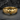 Close-up of the handcrafted winged equality ring resting on a textured dark slate stone background showing fine details.