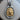 Close-up of handcrafted Leo lion pendant resting on wooden surface showing intricate mane detailing and leo text.