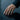 Person wearing the LGBT pride ring on their hand touching water, showcasing the elegant symbol design