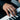 Modern minimalist band ring worn on man's finger resting on piano keys showing everyday style and comfortable fit