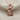 Crowned Horus Pendant, rose gold, on textured fabric