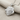 Twin Lion Pendant, polished silver, angled view on fabric