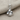 Stemmed Rose Pendant, polished, front view on textured fabric