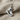 Hockey skate pendant in polished silver, detailed view on fabric