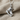 Hockey skate pendant in polished silver, detailed view on fabric
