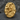 Close-up detail of rock climber ring showing deep oxidized texture and high-relief gold bouldering figure