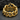 Close-up of the handcrafted broken chain ring resting on dark stone highlighting its intricate sculptural details