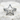 Chevron Nautical Star Ring, polished silver, front view on stone surface