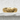 Close-up side angle of the elegant sterling silver floral band ring resting beautifully on a textured white stone surface