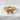 Close-up angled view of gold vermeil pave bow ring highlighting intricate metalwork and stone setting on textured surface.