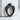 Scroll Heart Ring, black rhodium, upright front view on concrete
