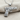 Rose Wrapped Handgun Pendant, polished silver, front view on fabric