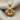 Close-up of handcrafted lotus flower pendant elegantly displayed on soft linen cloth revealing meticulous metalwork.