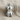 Teddy bear pendant in polished silver, front view on fabric