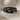 Double Knot Ring, black rhodium, front view resting on textured cloth