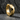 Angled view of thick chunky faceted hoop earring resting on dark slate displaying sharp architectural lines