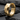Detailed view of faceted geometric hoop earring resting on dark slate highlighting clean architectural metalwork