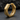 Close-up of geometric octagon hoop earring resting on dark textured stone background showcasing premium finish