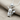 Electric Mouse Pendant, polished silver, front angled view on linen
