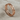 Close-up of the delicate 925 sterling silver heart eternity ring with elegant plating resting on a soft beige cloth