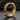 Close-up of premium snake hoop earring with hinged closure and sharp texturing on dark stone background.