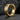 Close-up of modern gold vermeil grooved hoop earring resting on dark textured stones highlighting sleek design